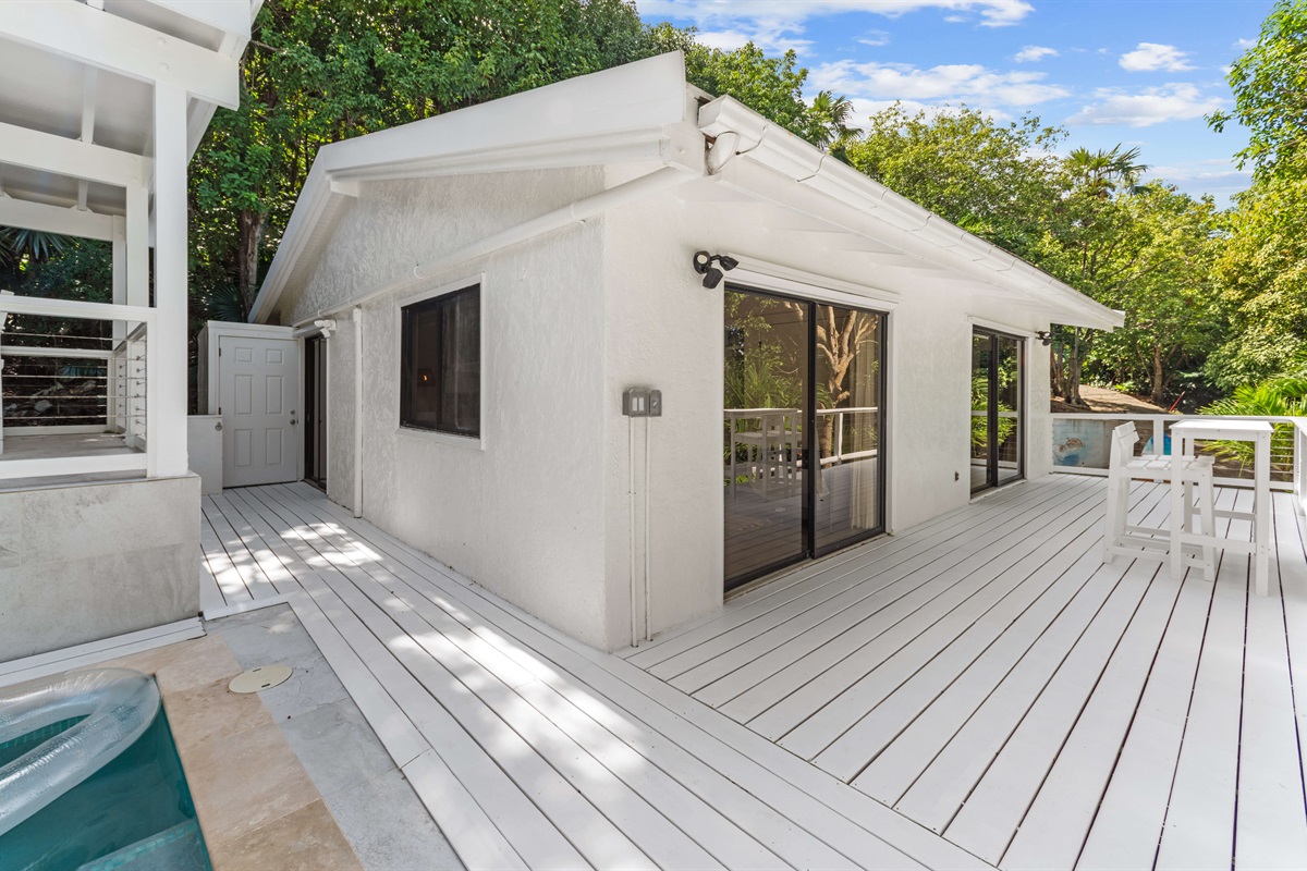 Balcony wraps around the home bringing you to the private pool and outdoor dining area