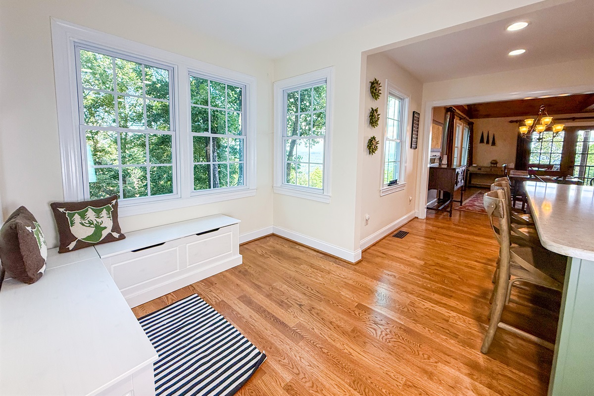 A cozy nook with built-in benches sits in the kitchen corner, perfect for morning coffee or a quiet read.