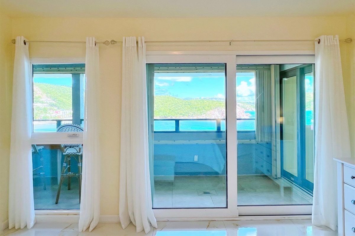 Glass doors let the natural light in, while soft curtains ensure a restful night.