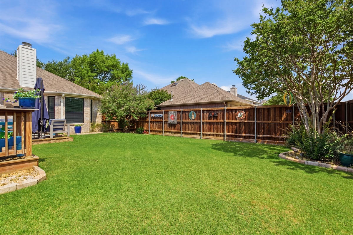 Lush green Backyard with tall trees and a privacy fence. Plenty of open space for kids to play, with the Patio and propane BBQ Grill just steps from the back door.
