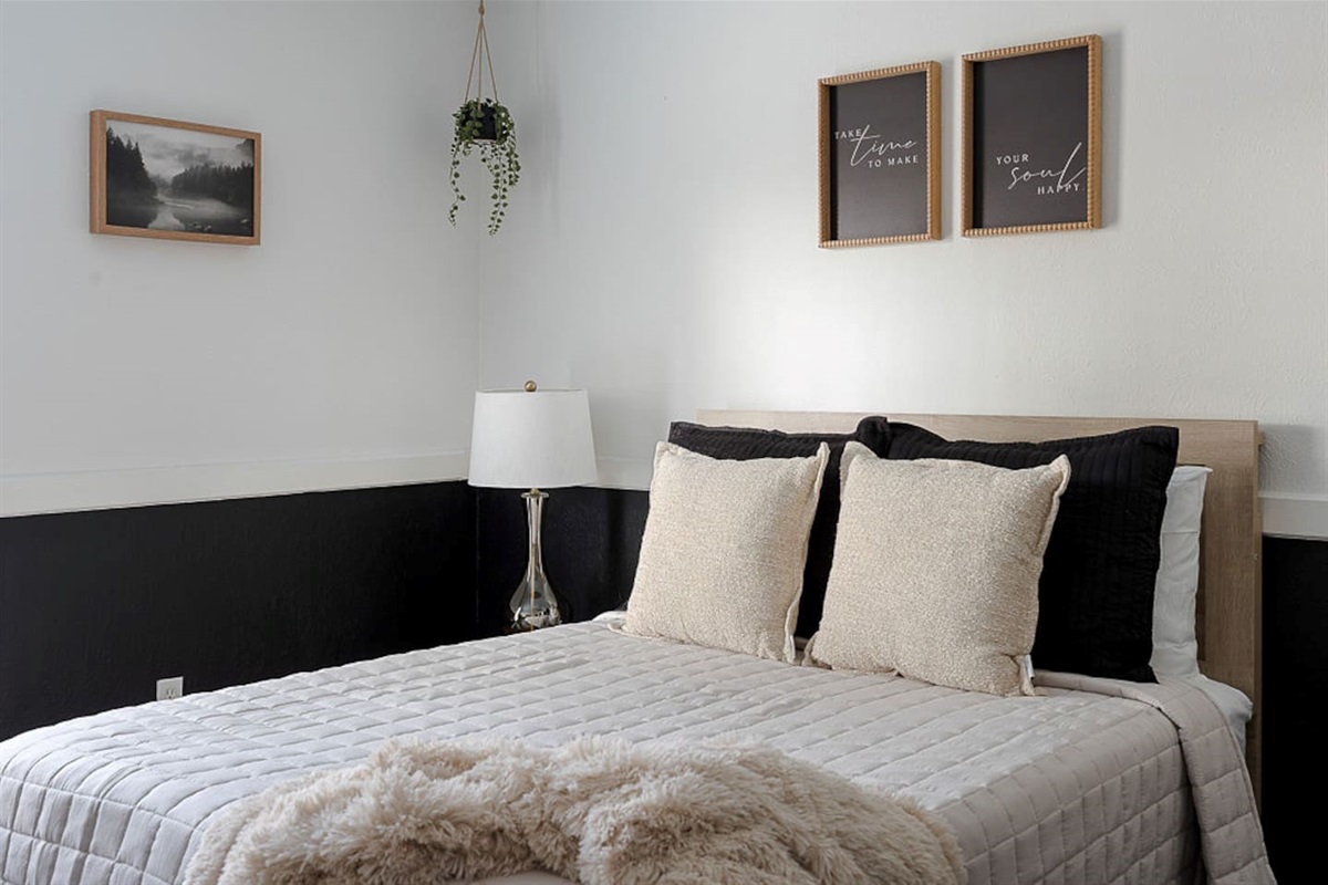 Enjoy this serene bedroom with a queen-size bed, nightstand, lamp and personal TV for your ultimate relaxation