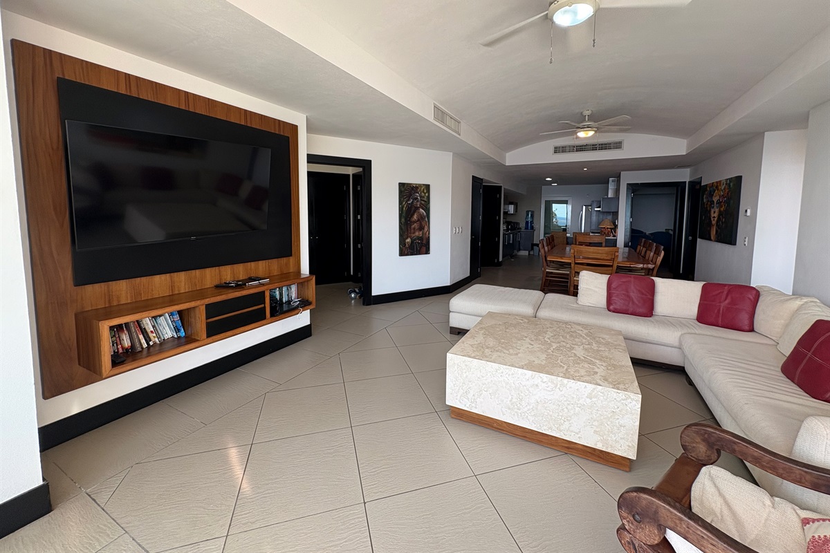 Living room TV area, bedroom entrance and kitchen