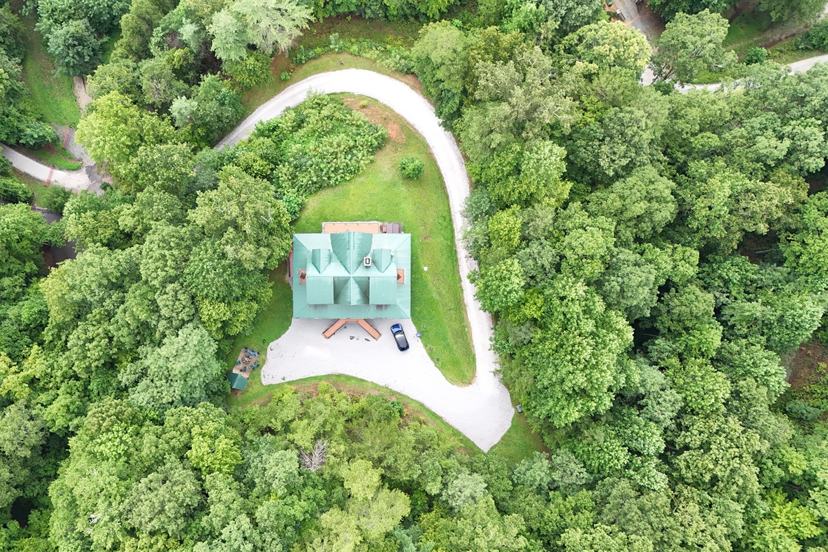 Aerial View: Nestled in nature, this charming retreat offers tranquility and adventure at every turn!