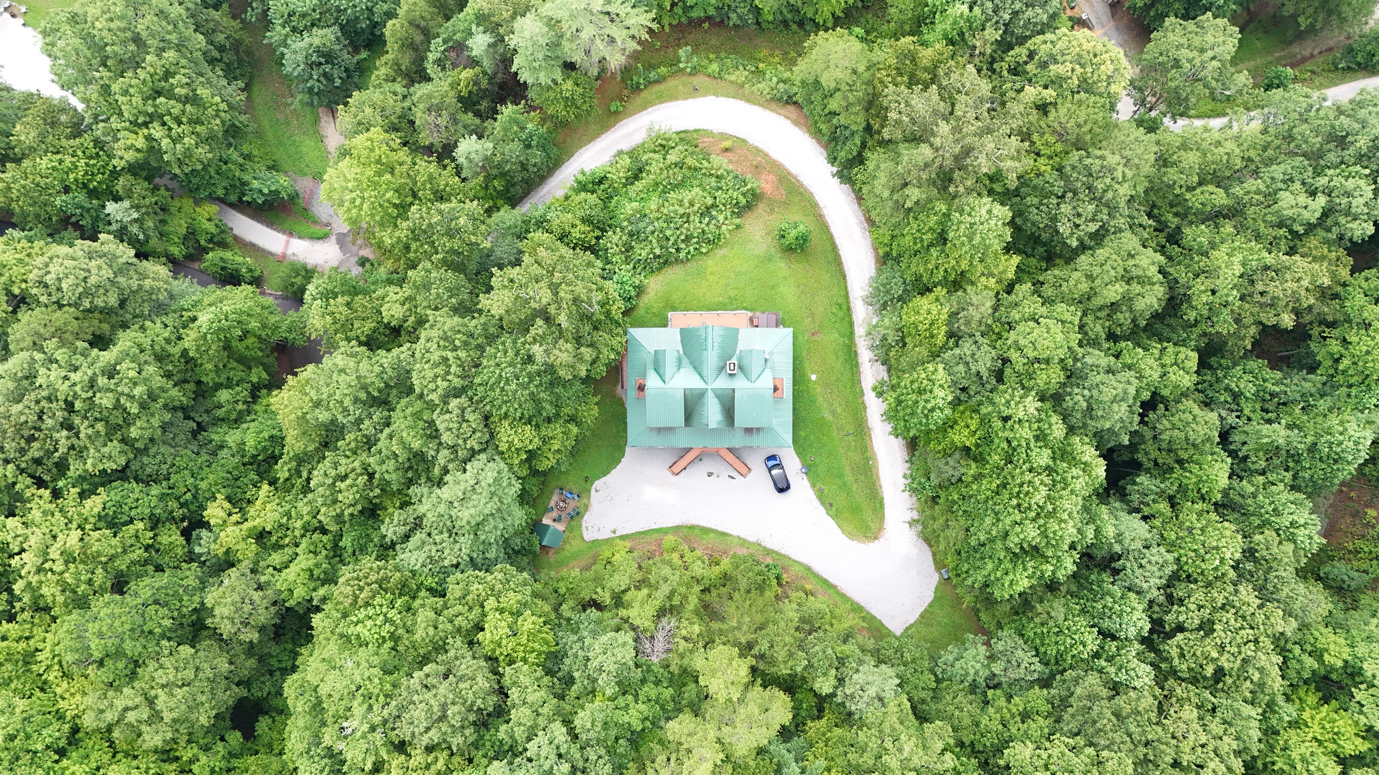 Aerial View: Nestled in nature, this charming retreat offers tranquility and adventure at every turn!