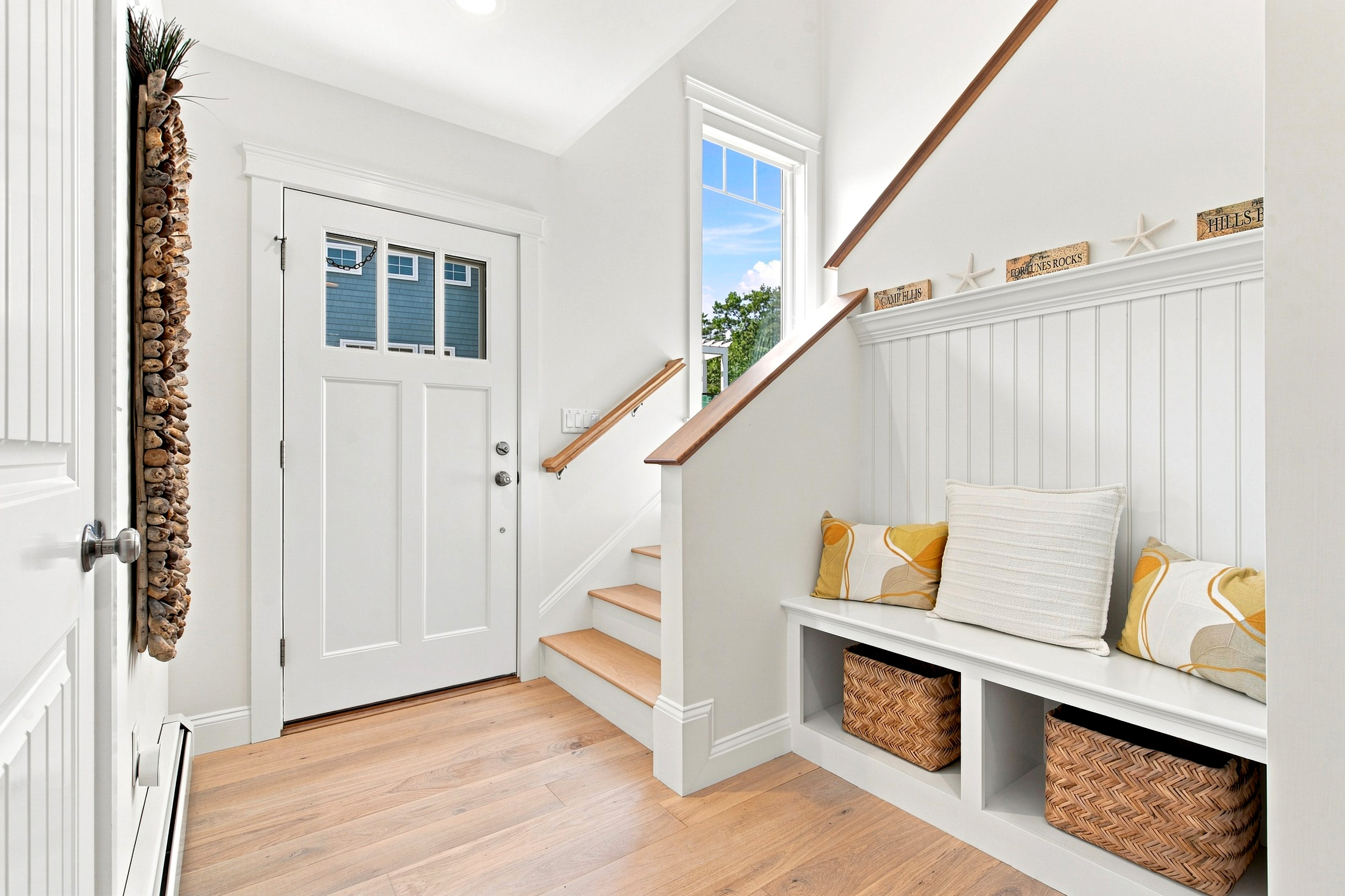 A welcoming entryway with built-in seating makes coming and going easy while keeping beach-day essentials organized.
