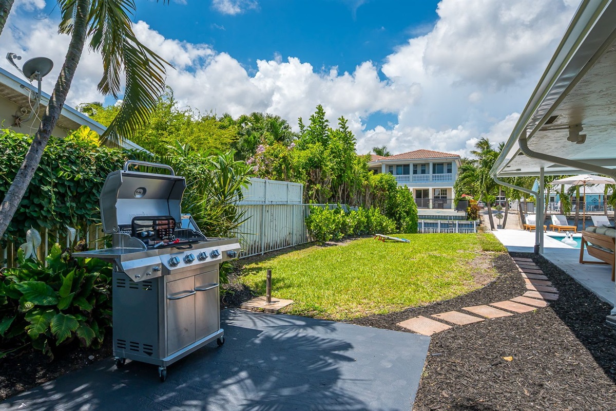Step outside to your private backyard oasis, complete with a stainless steel barbecue grill and lush tropical landscaping. Whether you’re grilling up a family feast, lounging poolside, or enjoying the canal views, this space is designed for relaxation.