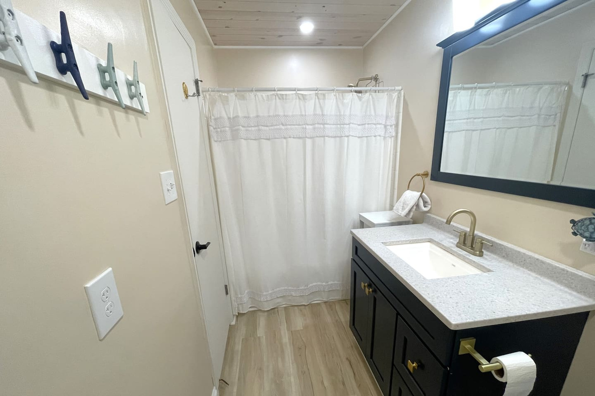 Soak in the tub or use the shower &mdash; your guest bathroom has both, and there's room for the whole group to take turns comfortably.