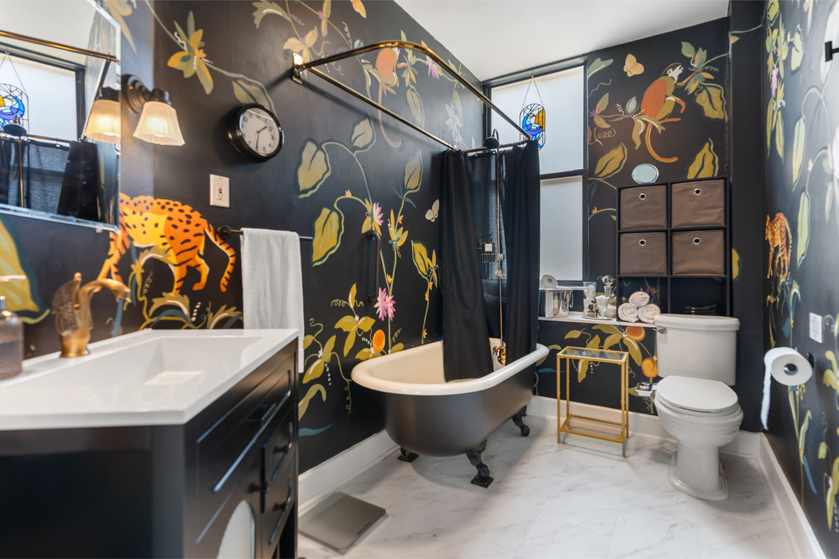 A clawfoot tub surrounded by hand-painted art? The 2nd floor bathroom deserves its own moment.