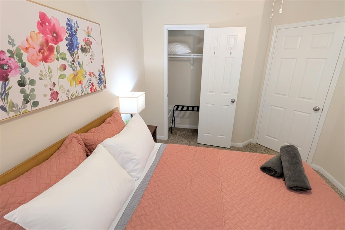 The queen bedroom has plenty of space in the closet for storage as well as hooks on the door. 