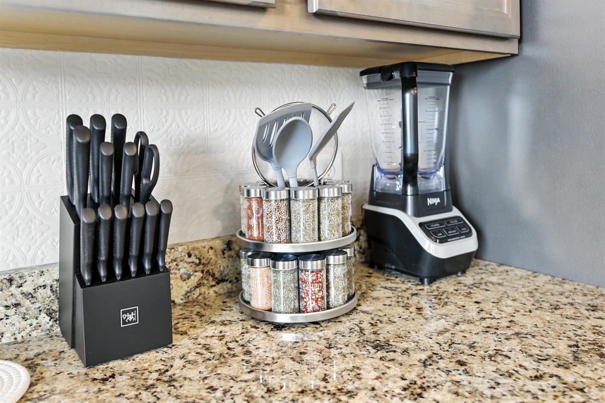 Well-stocked kitchen with Ninja blender, full spice selection, and knife set