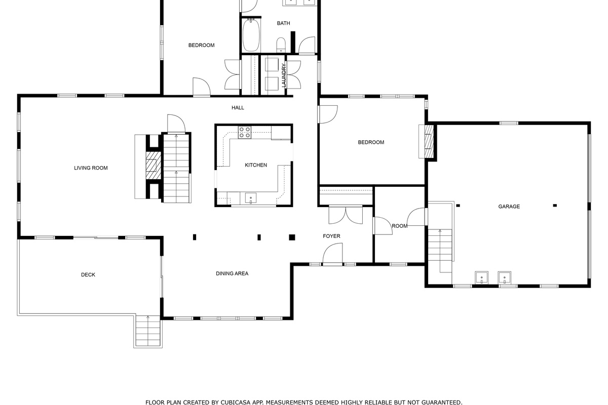 Main level floor plan with living room, kitchen, dining area, two bedrooms and deck