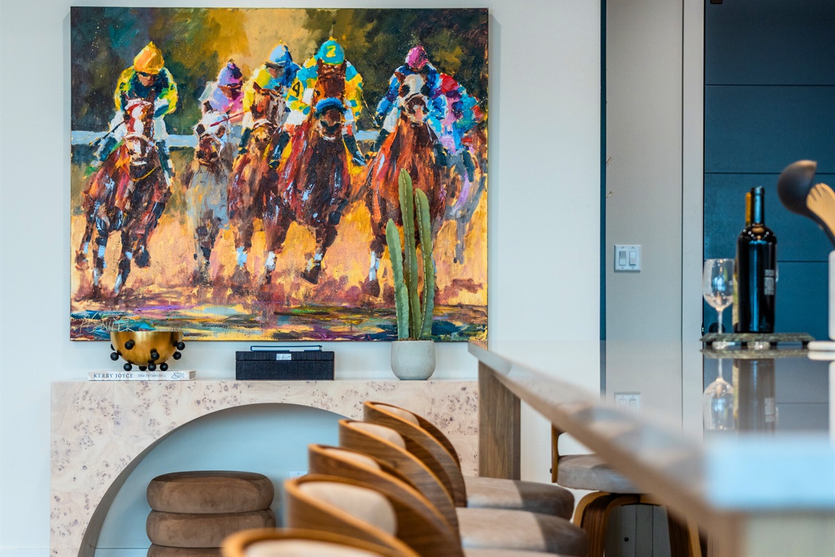 This vibrant artwork adds a burst of color and energy to the dining area, making it a lively spot for gatherings.