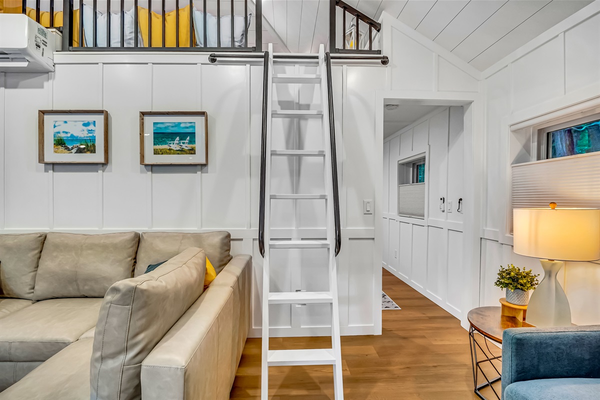 Loft is only accessible by ladder. It can be pushed up against the wall when not in use. 