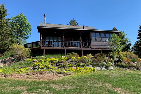 View from backyard i.e. Lake Superior showing enclosed porch, cover and uncovered deck. 