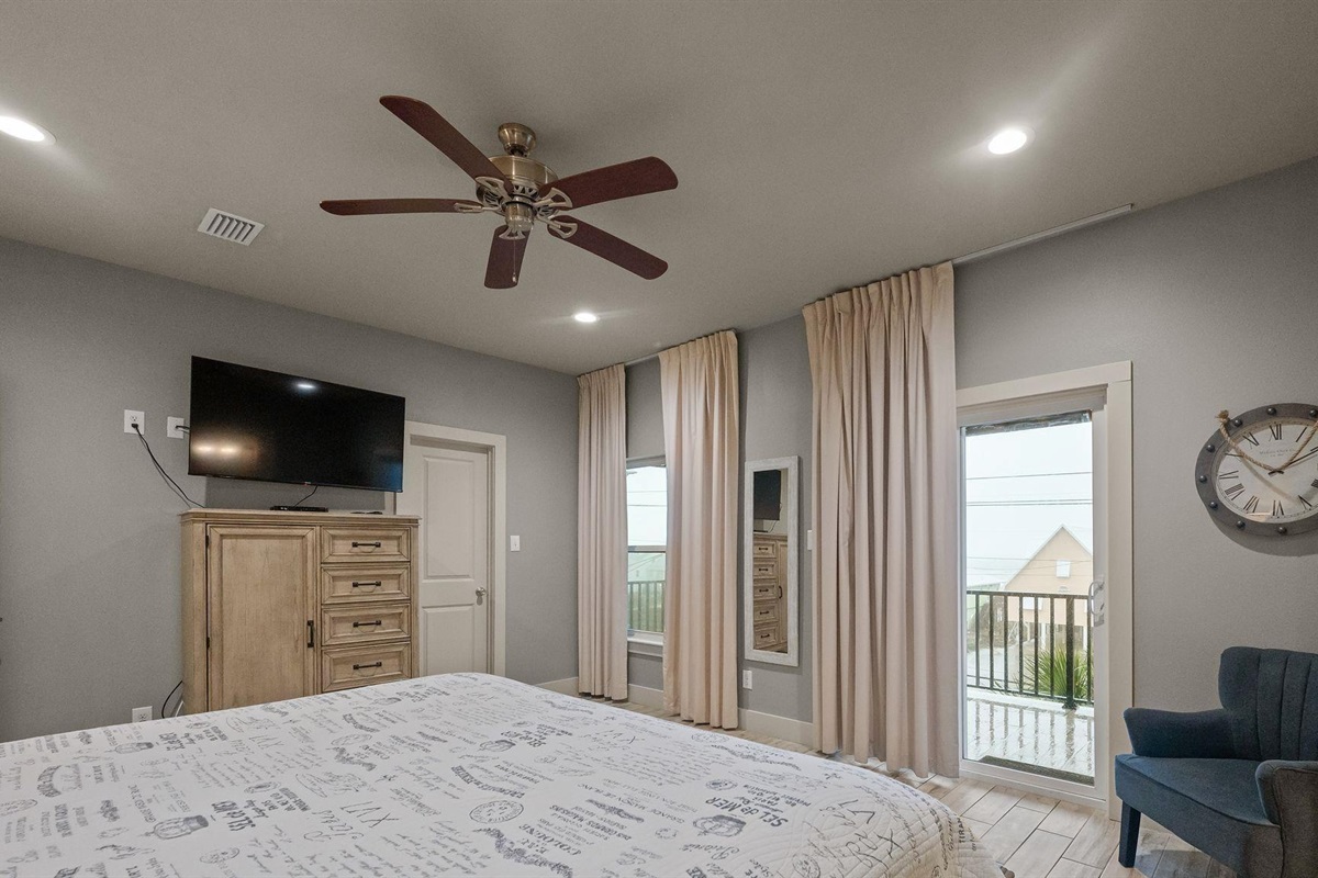 Bedroom with king bed, ceiling fan, TV and en-suite bathroom 
