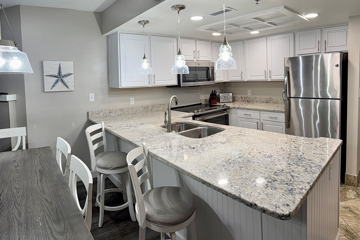 Dining table seats six plus two barstools.