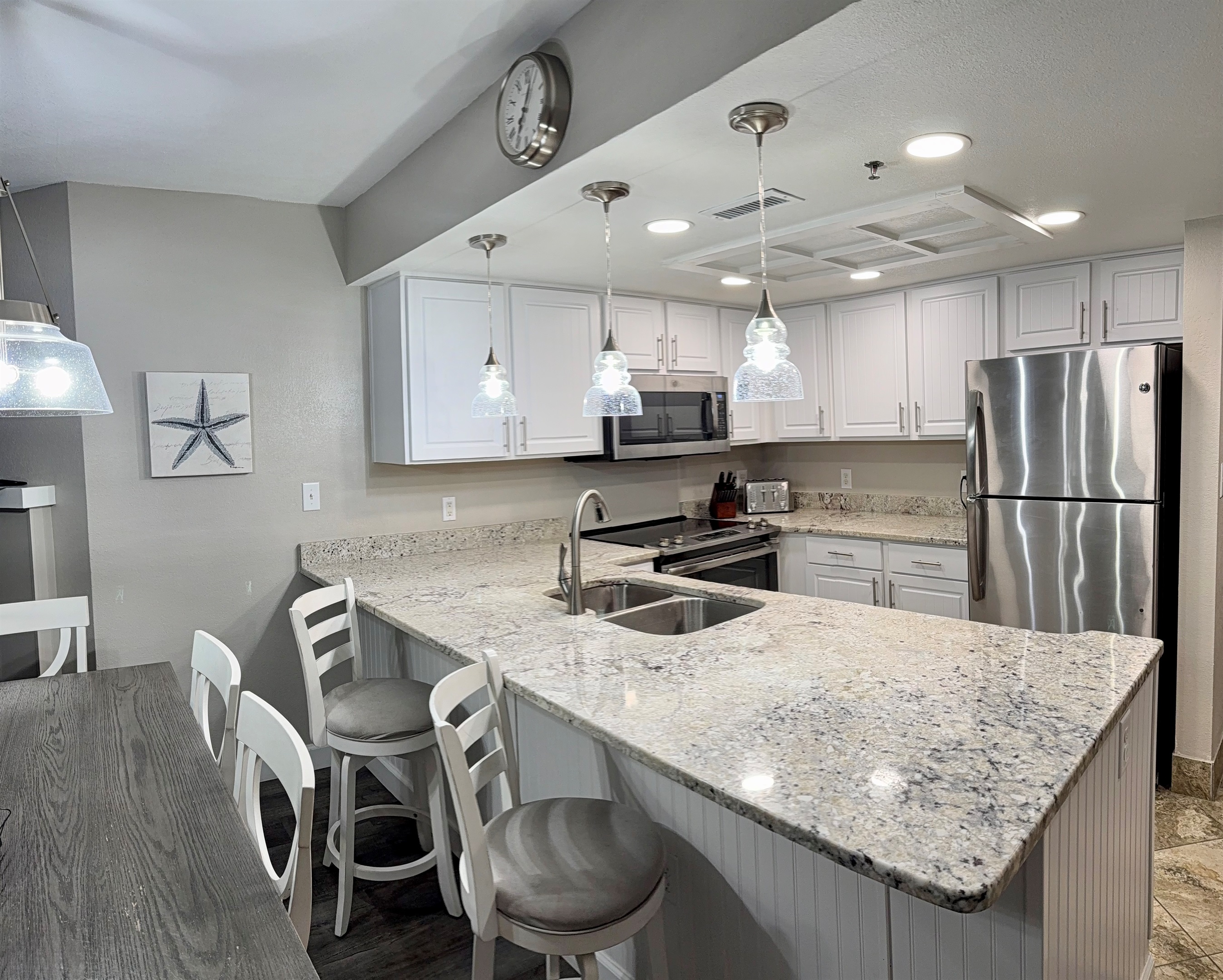 Dining table seats six plus two barstools.