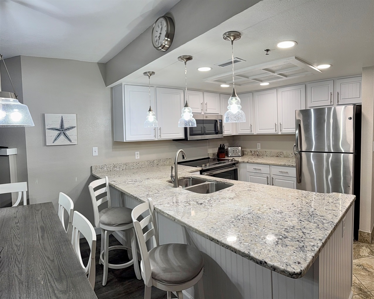 Dining table seats six plus two barstools.