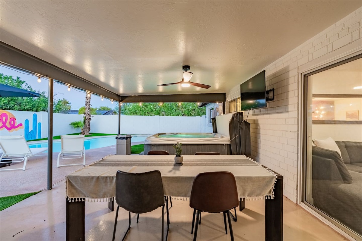 Relax in the hot tub just steps away from the outdoor dining table—ideal for evenings after a long day of exploring.

