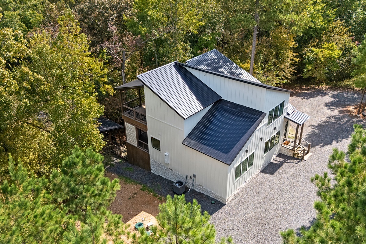 Rear exterior showing deck and wooded privacy.