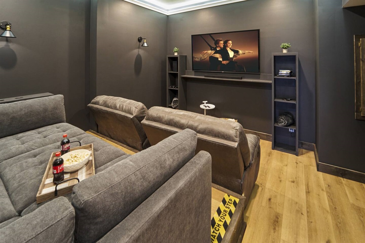 Comfortable lounge couch, recliners, Xbox, and surround sound in theater room