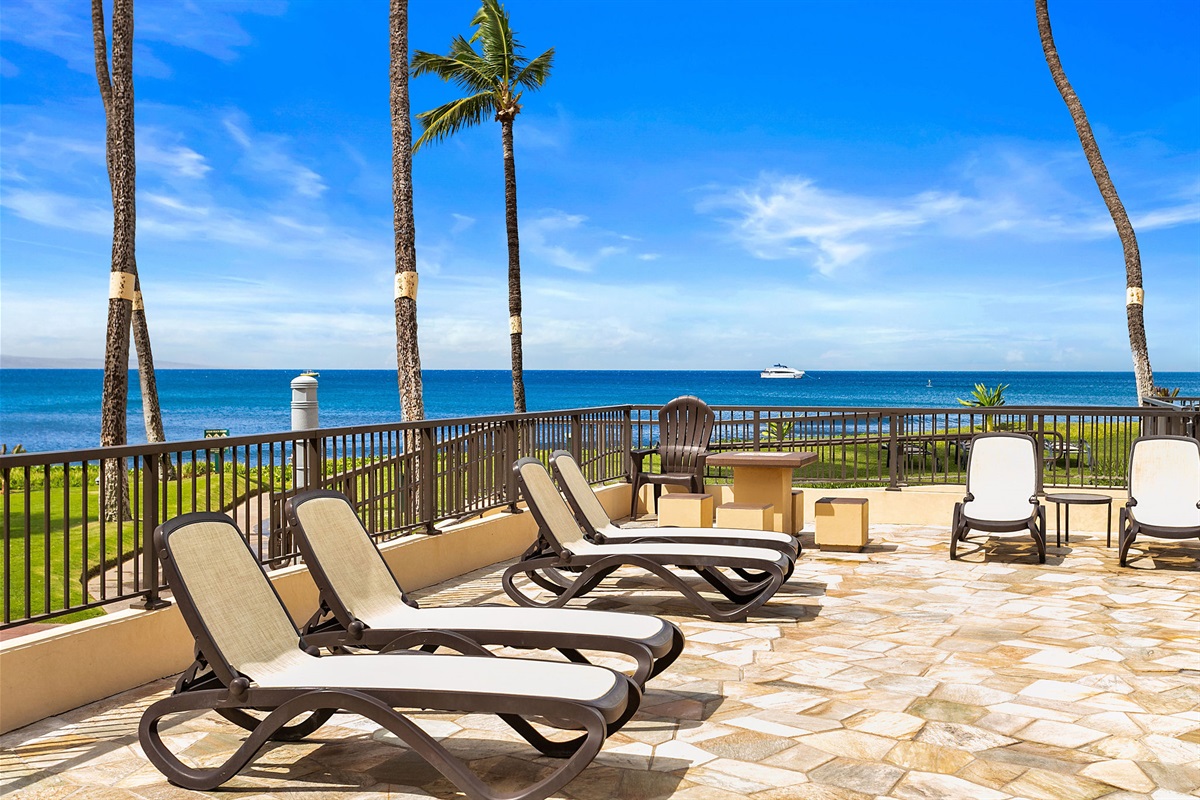 The oceanfront pool area with chaise lounges