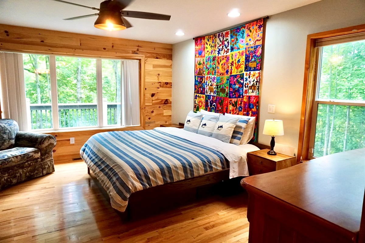 Bedroom Retreat: Bright space with artful decor, forest views, and plush furnishings await you!