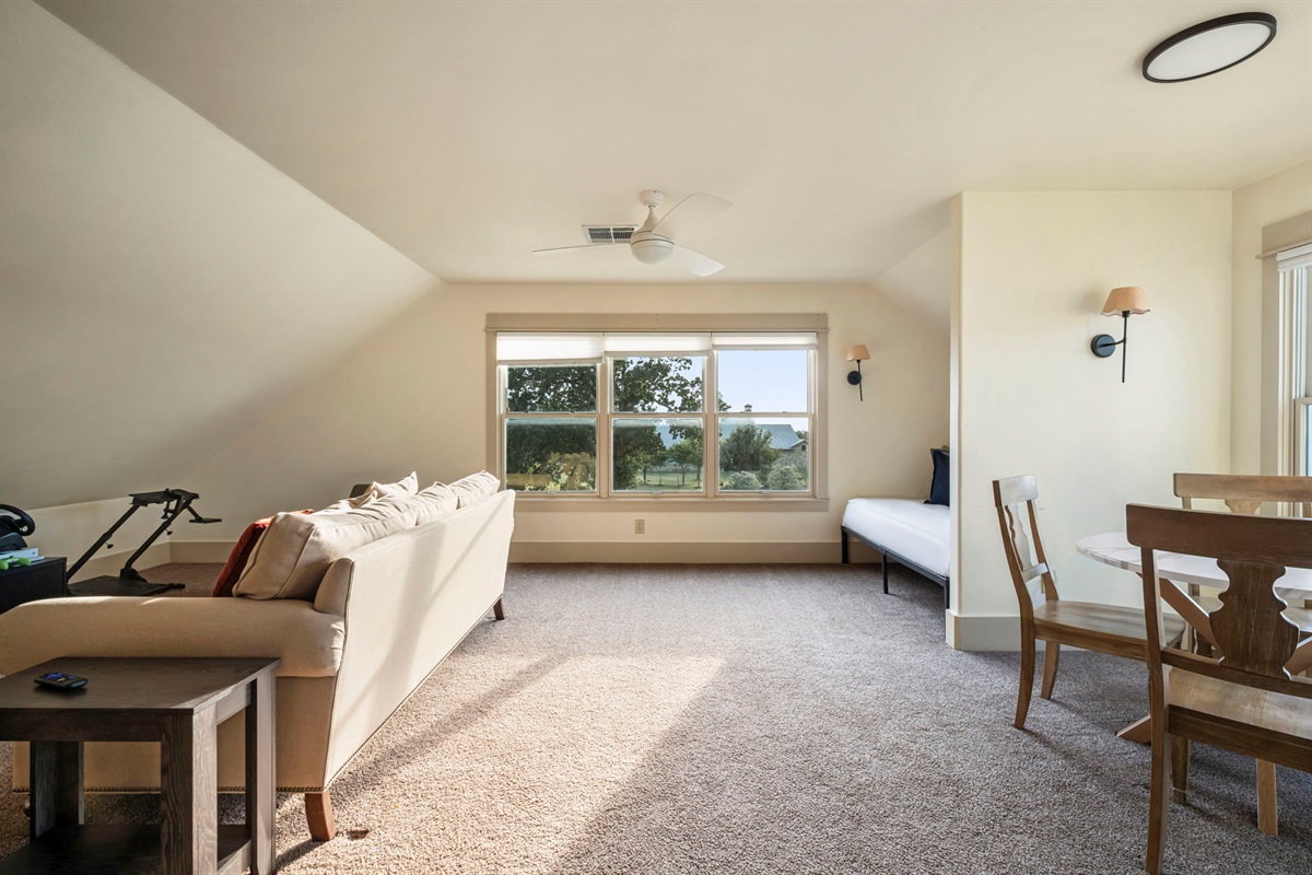 Large windows fill the space with natural light, creating a bright and inviting retreat.