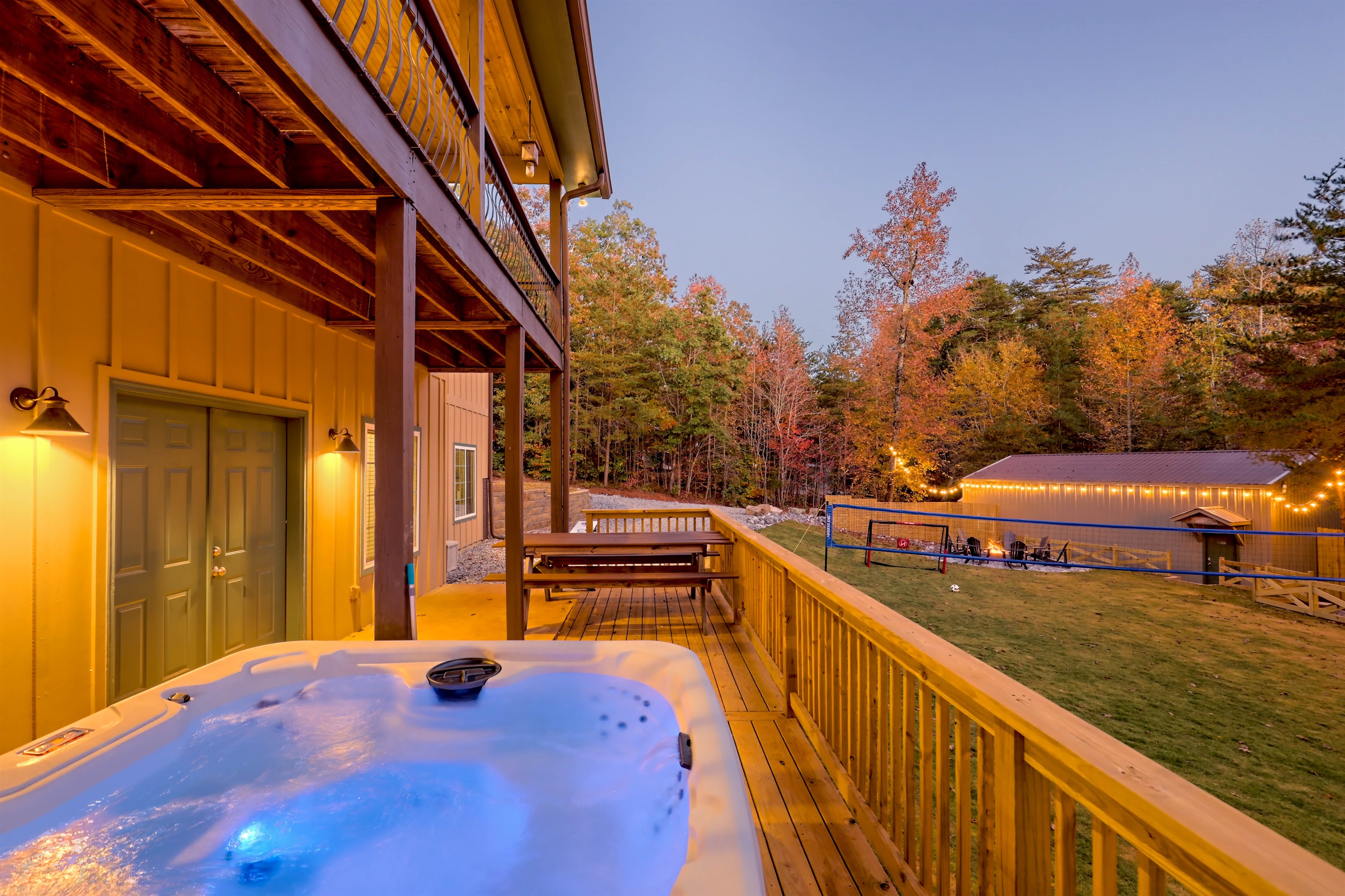 Unwind in the bubbling hot tub with serene views of the trees and backyard play areas—your own private retreat.