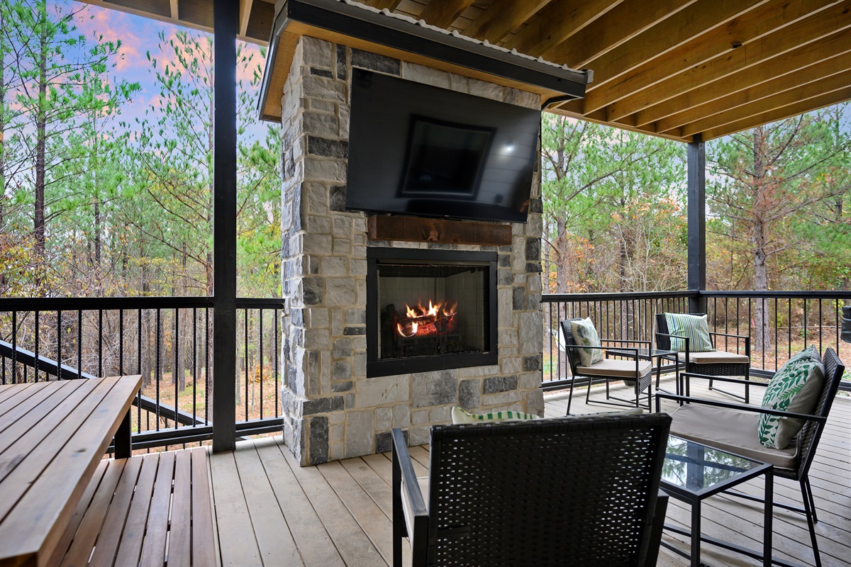 Lower level deck lounging, but make it luxury. 
Fresh air, a crackling fireplace, and peaceful forest views create the perfect spot to unwind between hot tub dips and slow evenings outside.