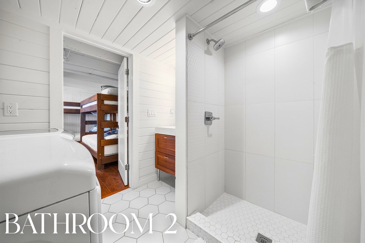 Fresh and bright bathroom with a walk-in shower to rinse off after lake days.