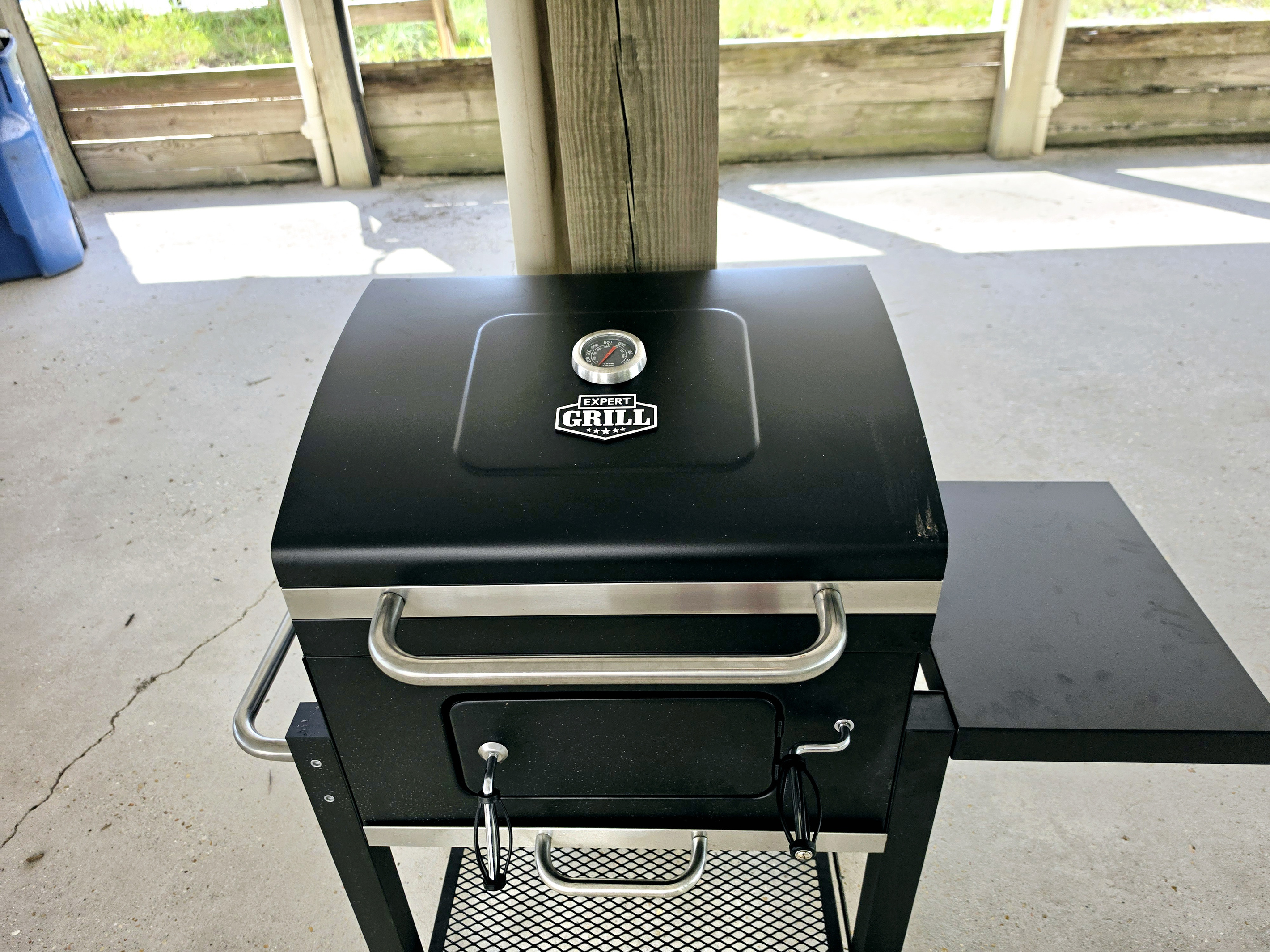 Outdoor grill in the covered area under the home