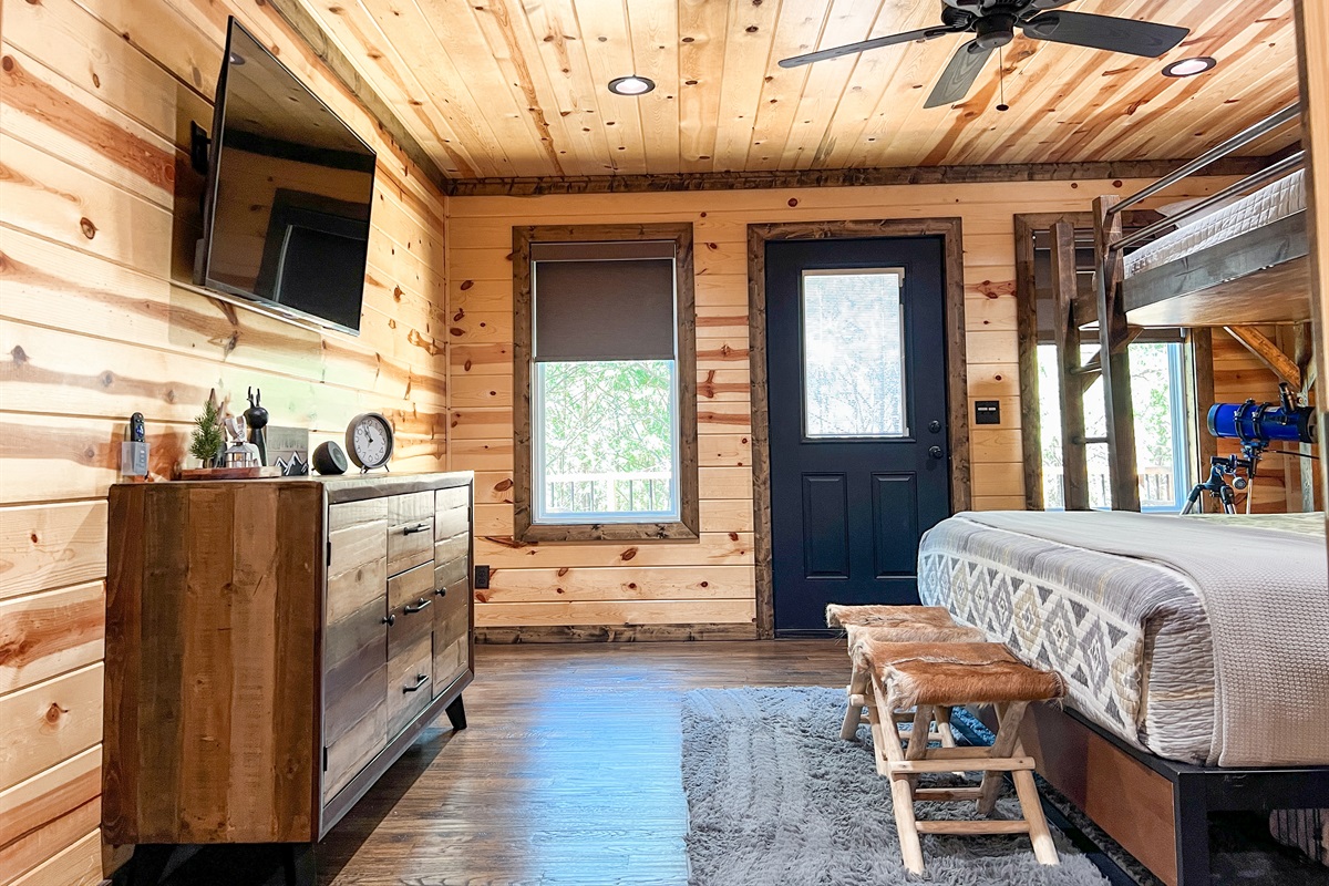 Smart TV and storage space in upstairs bedroom.