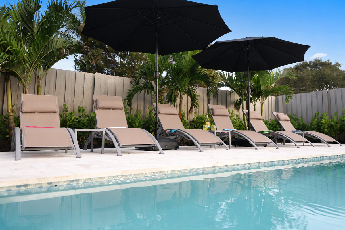 Lounge by the private pool, enjoy the palms, and keep the covered patio and backyard games within easy reach.