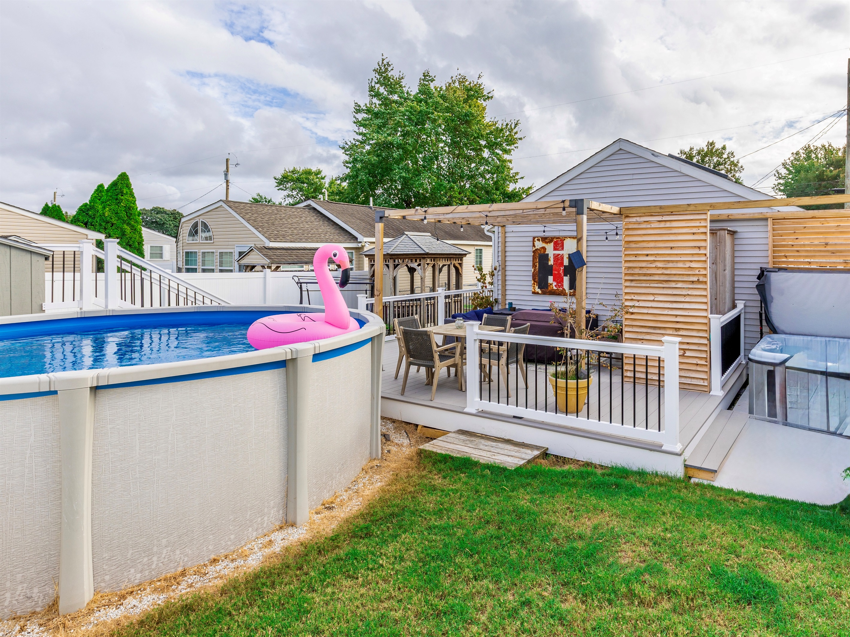backyard oasis! pool, hot tub, fire table, outdoor shower, dining AND lounge area!