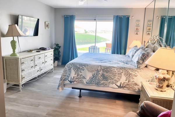 Master bedroom with king bed and patio access