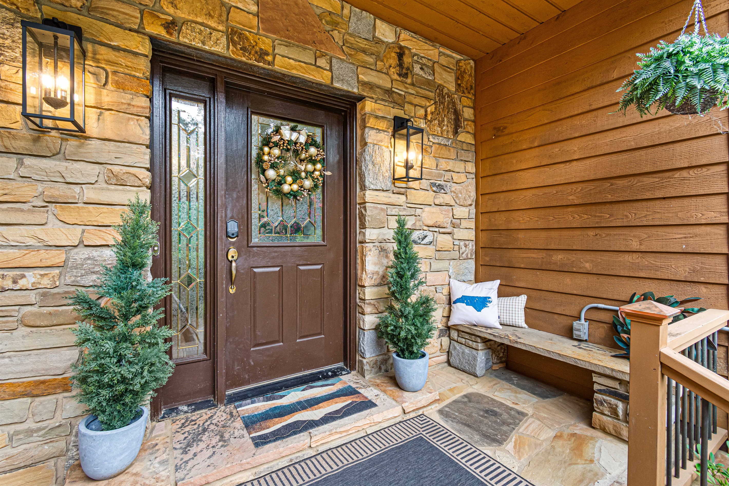 A warm welcome awaits—step through the stone-accented entry with cozy seating, charming décor, and thoughtful touches that set the tone for your stay at Twin Oaks Lodge.🌿🏡✨