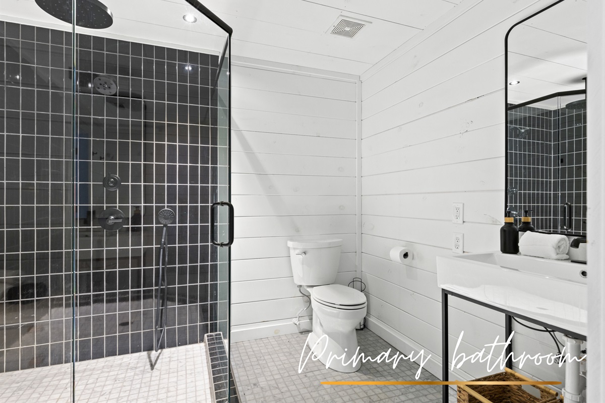 Freshen up in this sleek and modern bathroom, featuring luxurious finishes and plenty of space.