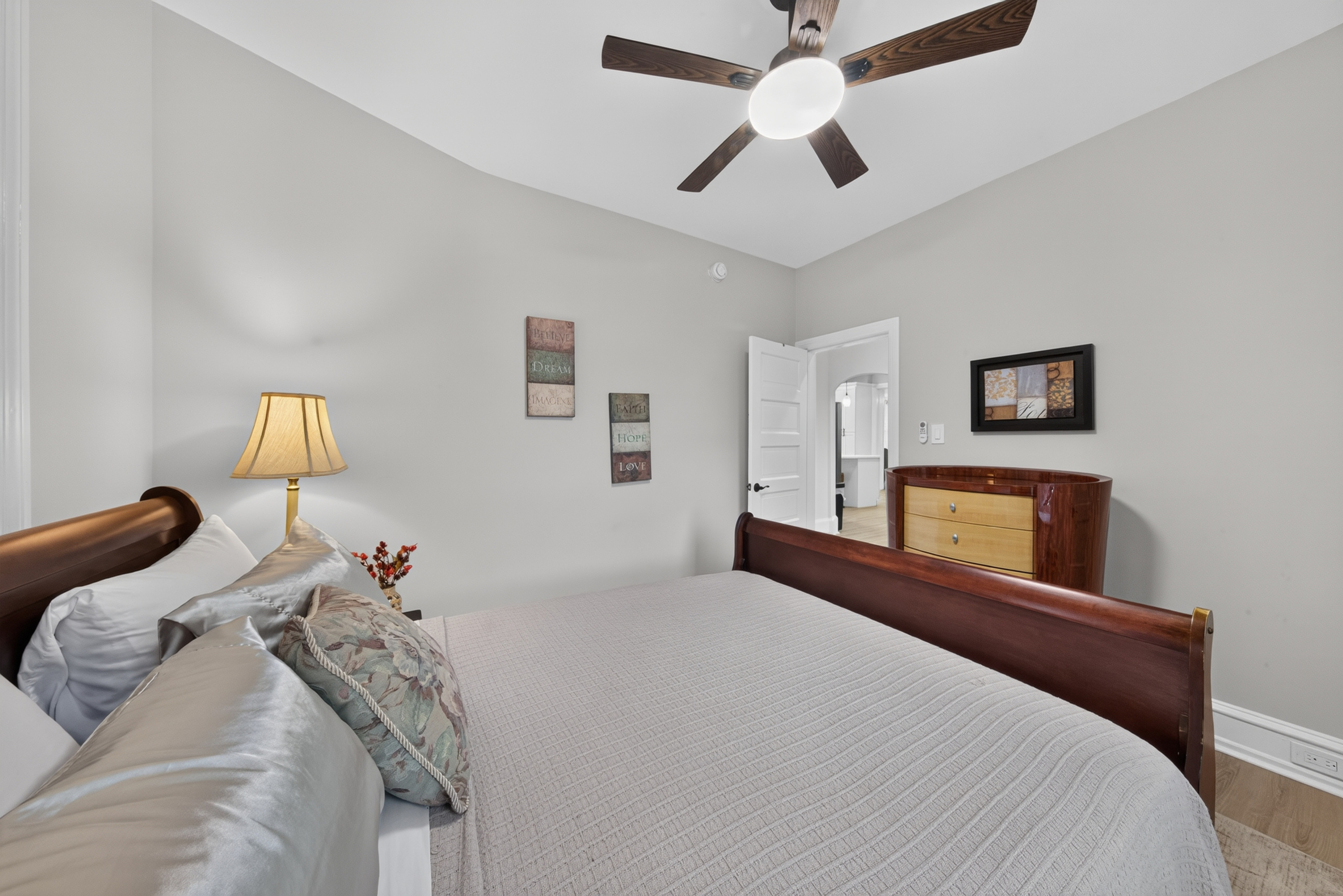 Ceiling fan, portable cooling options, and dresser storage for extended stays.