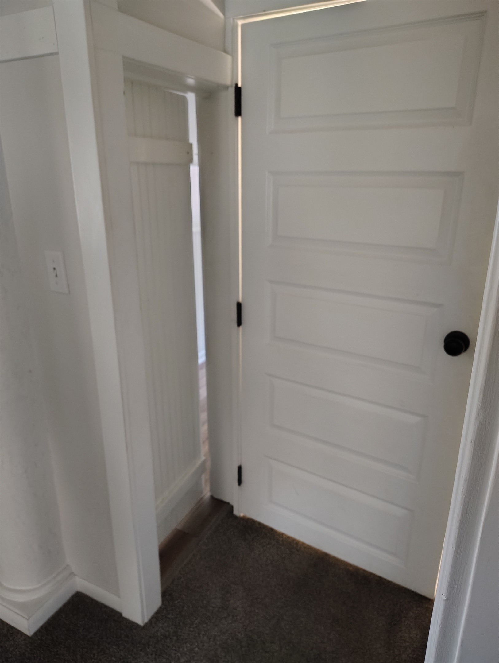Close door to upstairs and see secret door behind