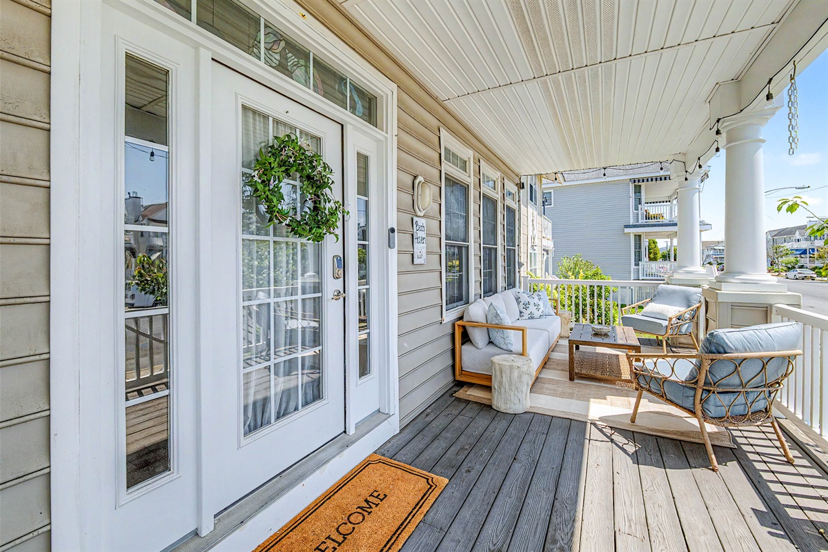 Large wrap around porch: 2 seating areas, 1 dining table