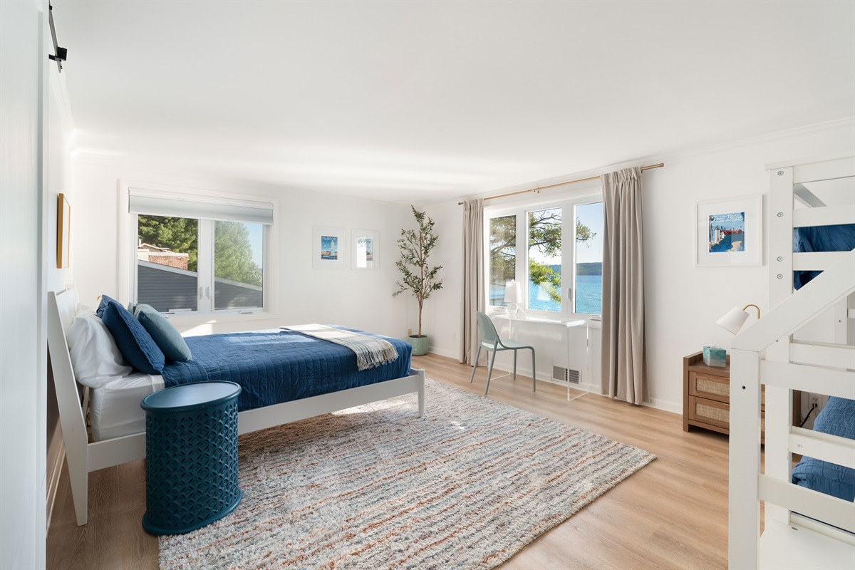 Bedroom 3 is great for the kiddos! A queen bed, bunk beds with a trundle and a secret play space... But, it does have a desk with a view you need to work remotely.