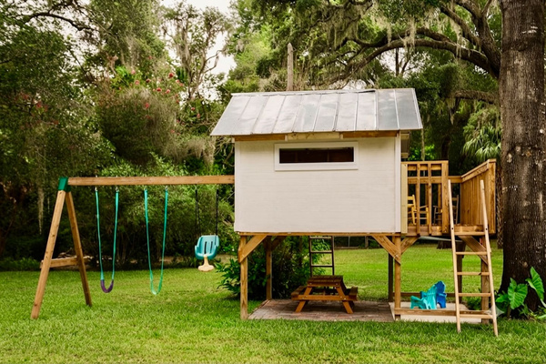 A swing set and playhouse under the oaks - hours of outdoor fun for the kids.