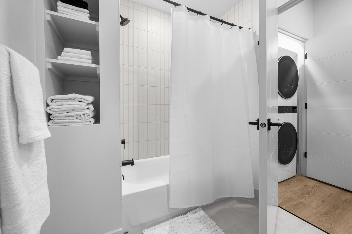 Clean, bright bathroom with plenty of storage for your stay.