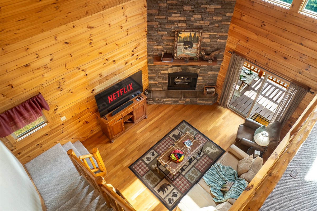 Living Room Oasis: Relax by the stone fireplace and enjoy movie nights with stunning views!