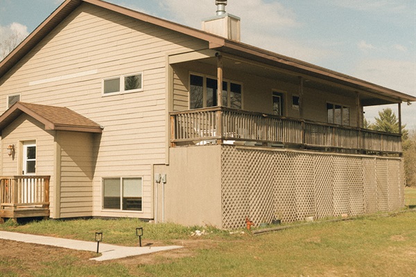 Entry door and large deck overlooking our large back yard and woods.
