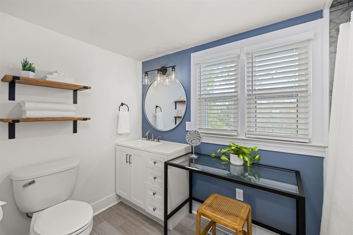 Magnolia Suite full bathroom includes a sink, toilet, tile shower, and seated vanity.