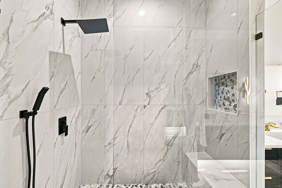 Experience a spa-like retreat with modern fixtures and elegant marble finishes!