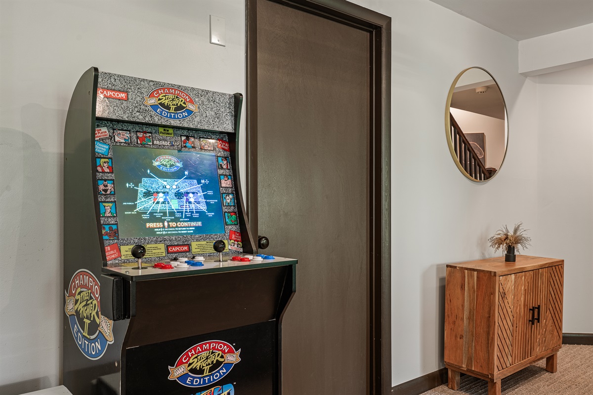 Unwind in the lower-level living room, equipped with a TV and cozy seating for movie nights or game days.