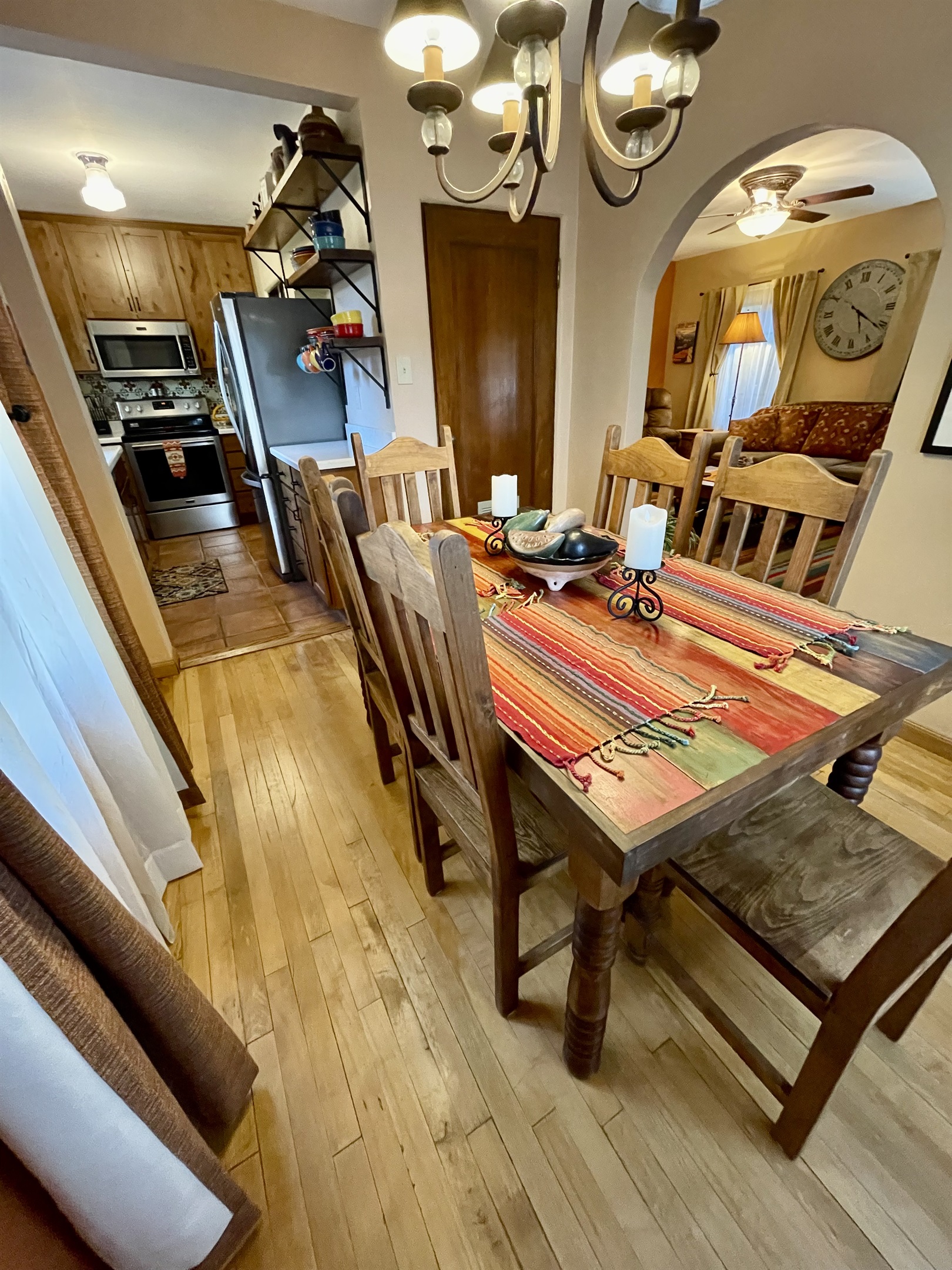 This inviting dining room features a beautiful wooden table, comfortable chairs, and warm natural light.